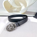 Dark faux-leather belt with ornate silver buckle and metal keeper strap