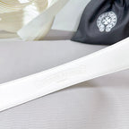 White leather belt with embossed brand logo on strap