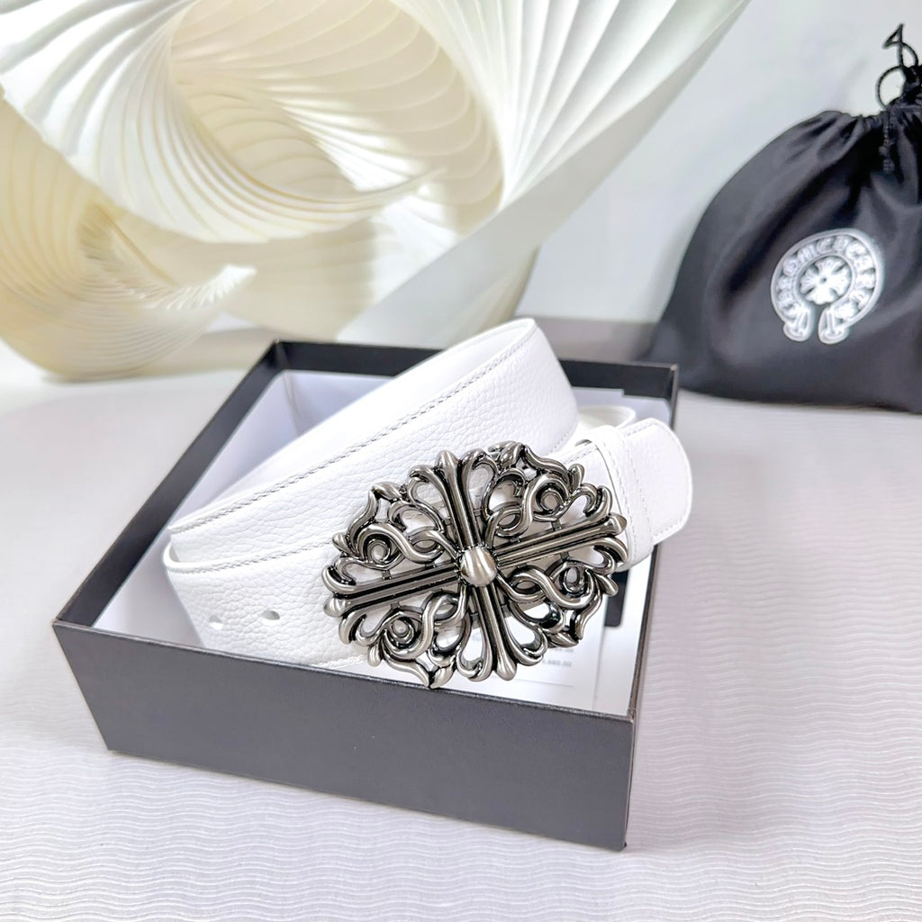 White leather belt with ornate silver-tone buckle on display box
