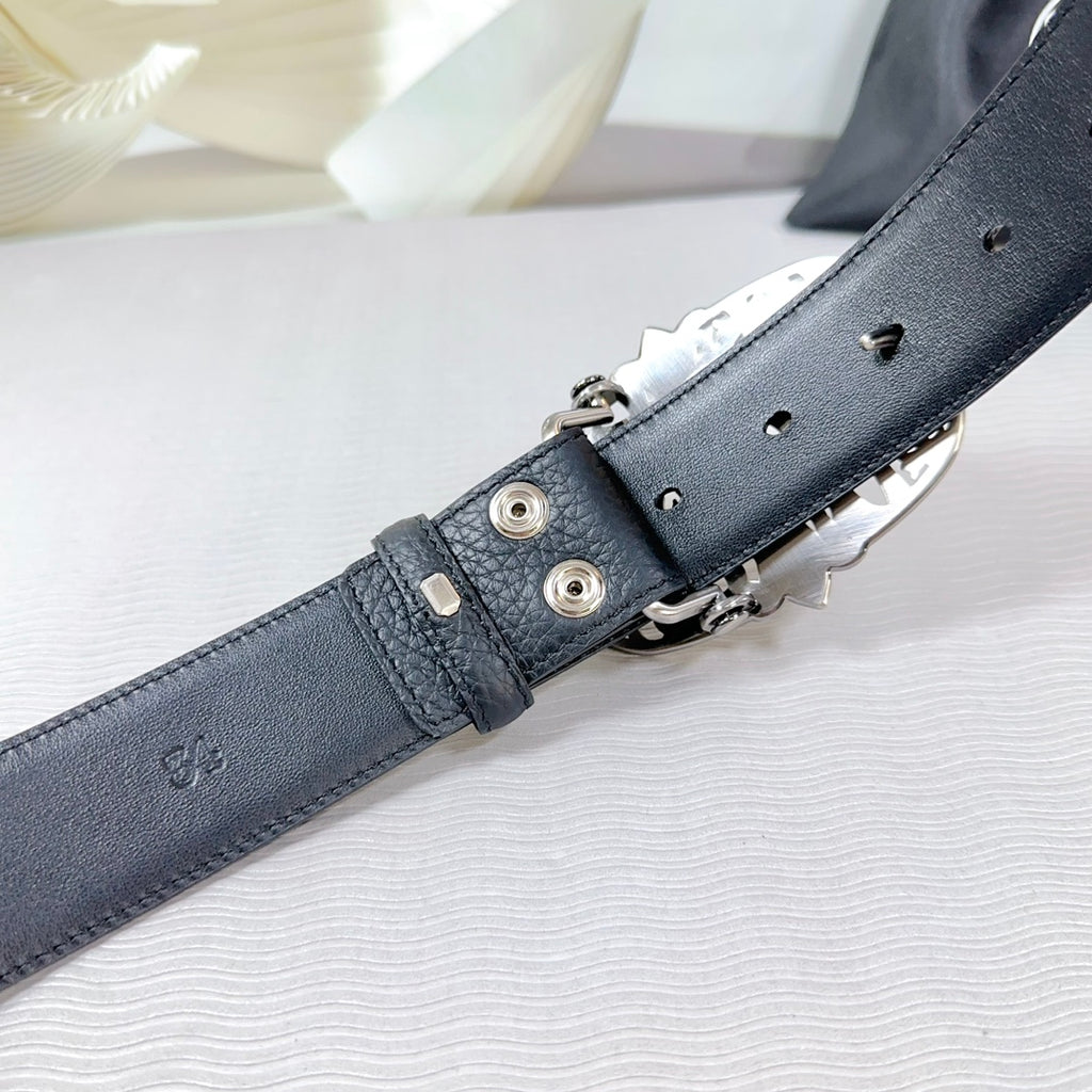 Chrome belt adjustment end: dark leather strap with metal clasp and hole section.