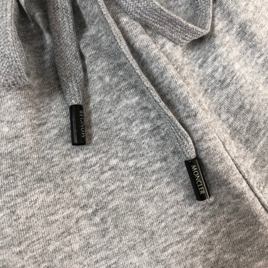 Heather gray shorts with black label tags near the hem, MONCLER