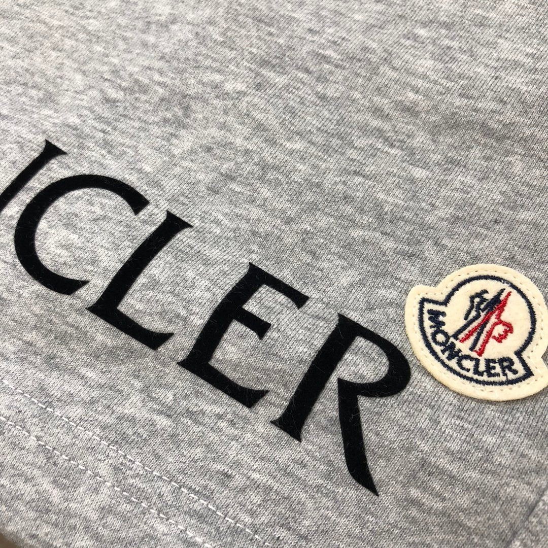 Heather gray shorts with MONCLER lettering and crest patch on the leg