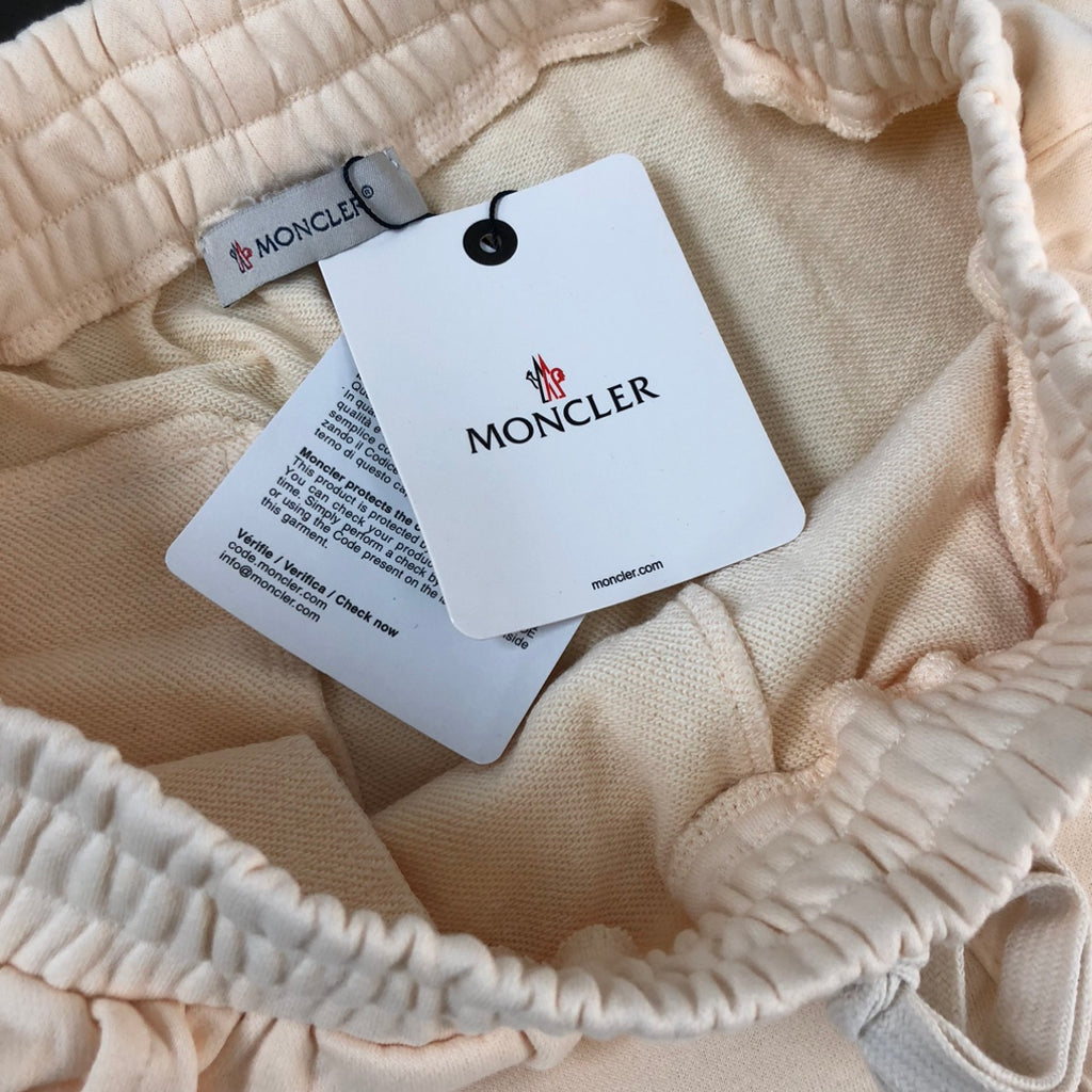 Cream shorts elastic waist with MONCLER tag and black drawcord aglets