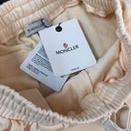 Cream shorts elastic waist with MONCLER tag and black drawcord aglets