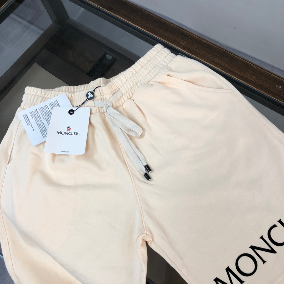 Cream drawstring shorts with black MONCLER lettering and front seam