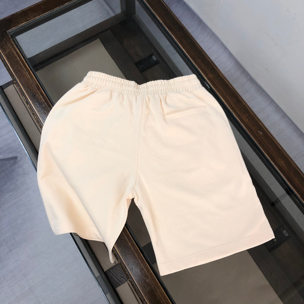 Cream drawstring shorts with stitched seams and smooth front