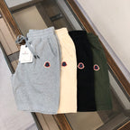 Set of drawstring shorts in gray, cream, black, and dark green with heart patches