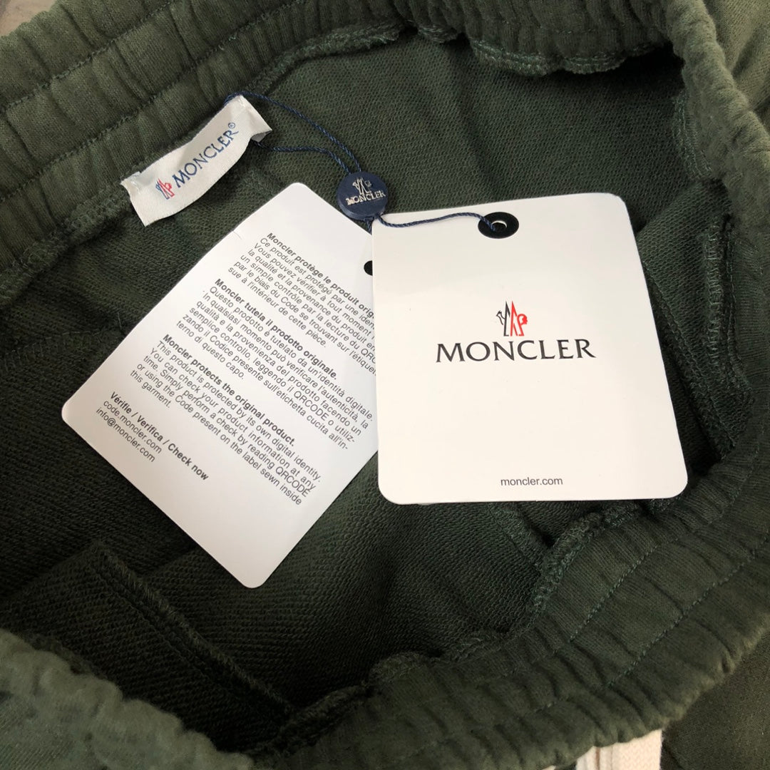 Dark green shorts with elastic waistband and Moncler hang tags