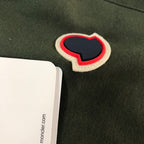 Heart-shaped patch applique on dark green shorts with red edging