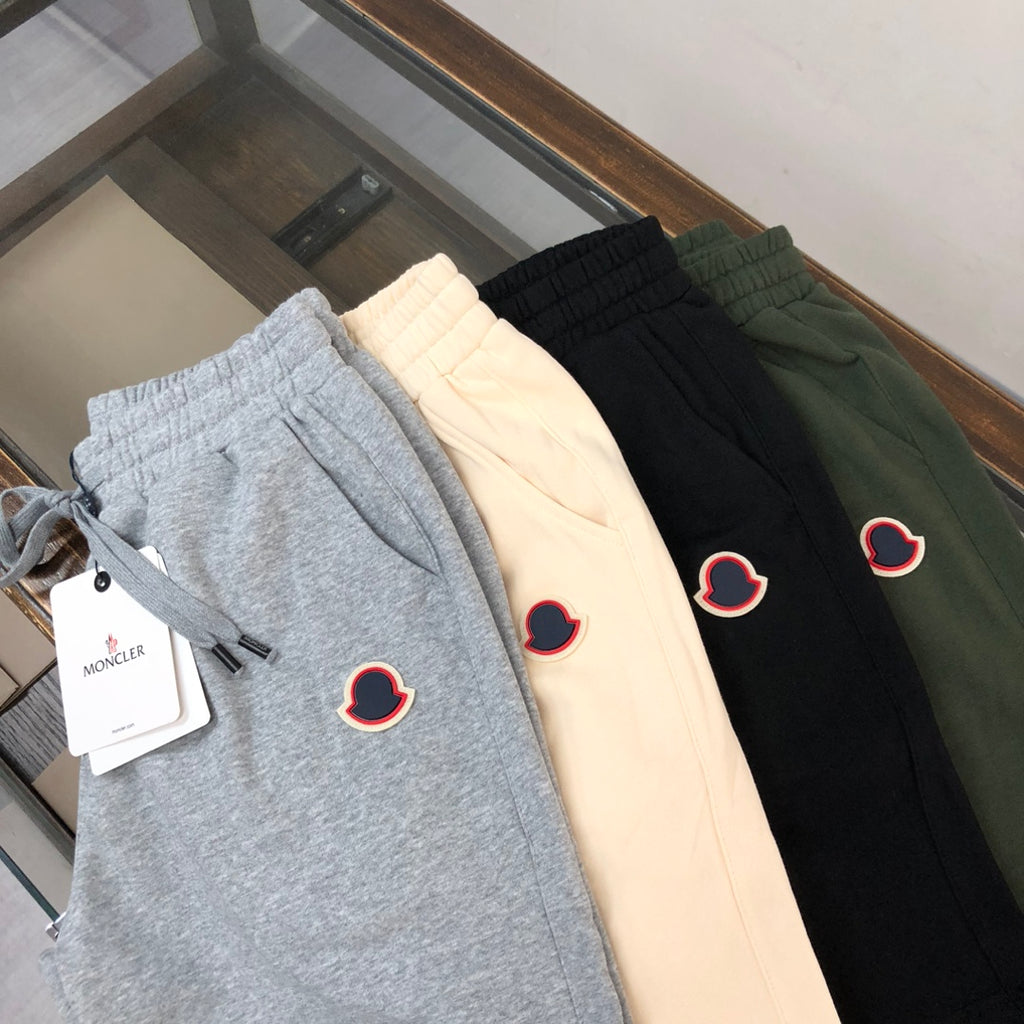 Set of shorts in light gray, cream, black, and dark green with heart logo patches