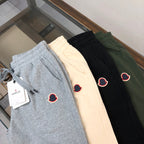 Set of shorts in light gray, cream, black, and dark green with heart logo patches
