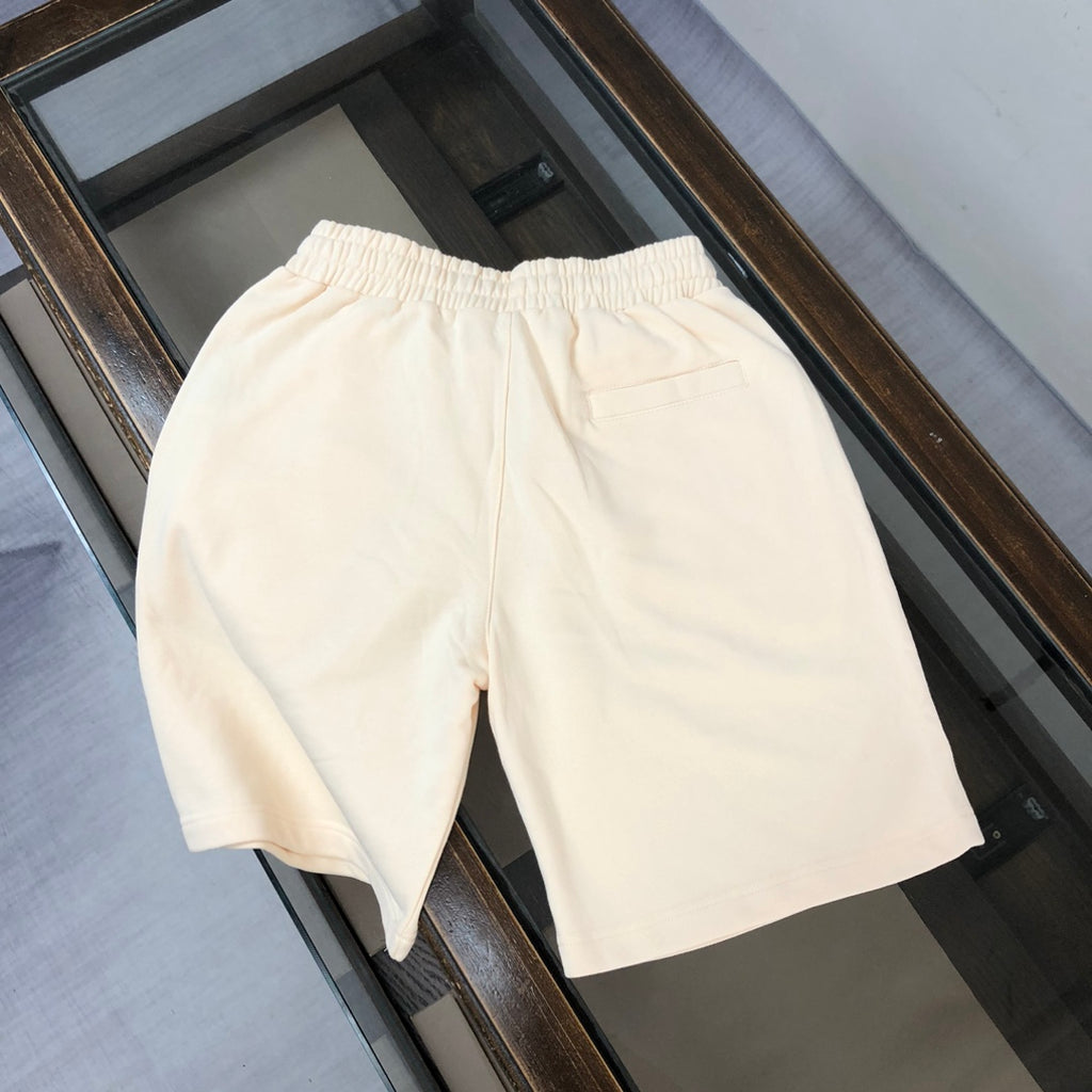 Cream shorts with elastic waistband and relaxed straight-leg silhouette
