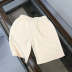Cream shorts with elastic waistband and relaxed straight-leg silhouette