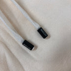 Cream shorts drawcord tips with black end caps and MONCLER-printed tags