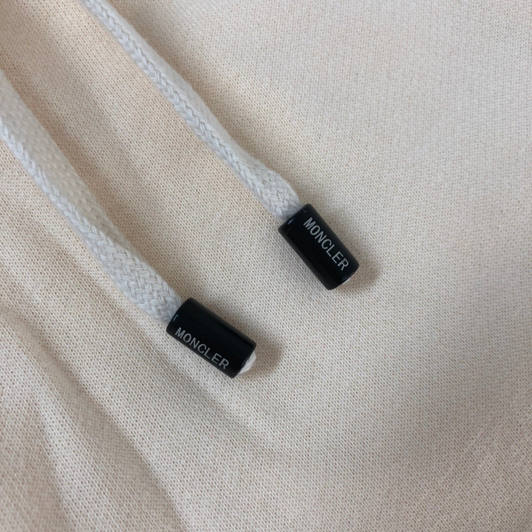 Cream shorts drawcord tips with black end caps and MONCLER-printed tags