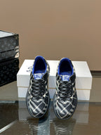 Low-top sneakers with blue interior lining and black and white plaid uppers