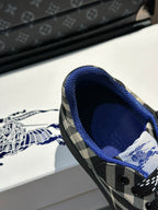 Close-up of sneaker interior with blue lining and black laces on plaid upper