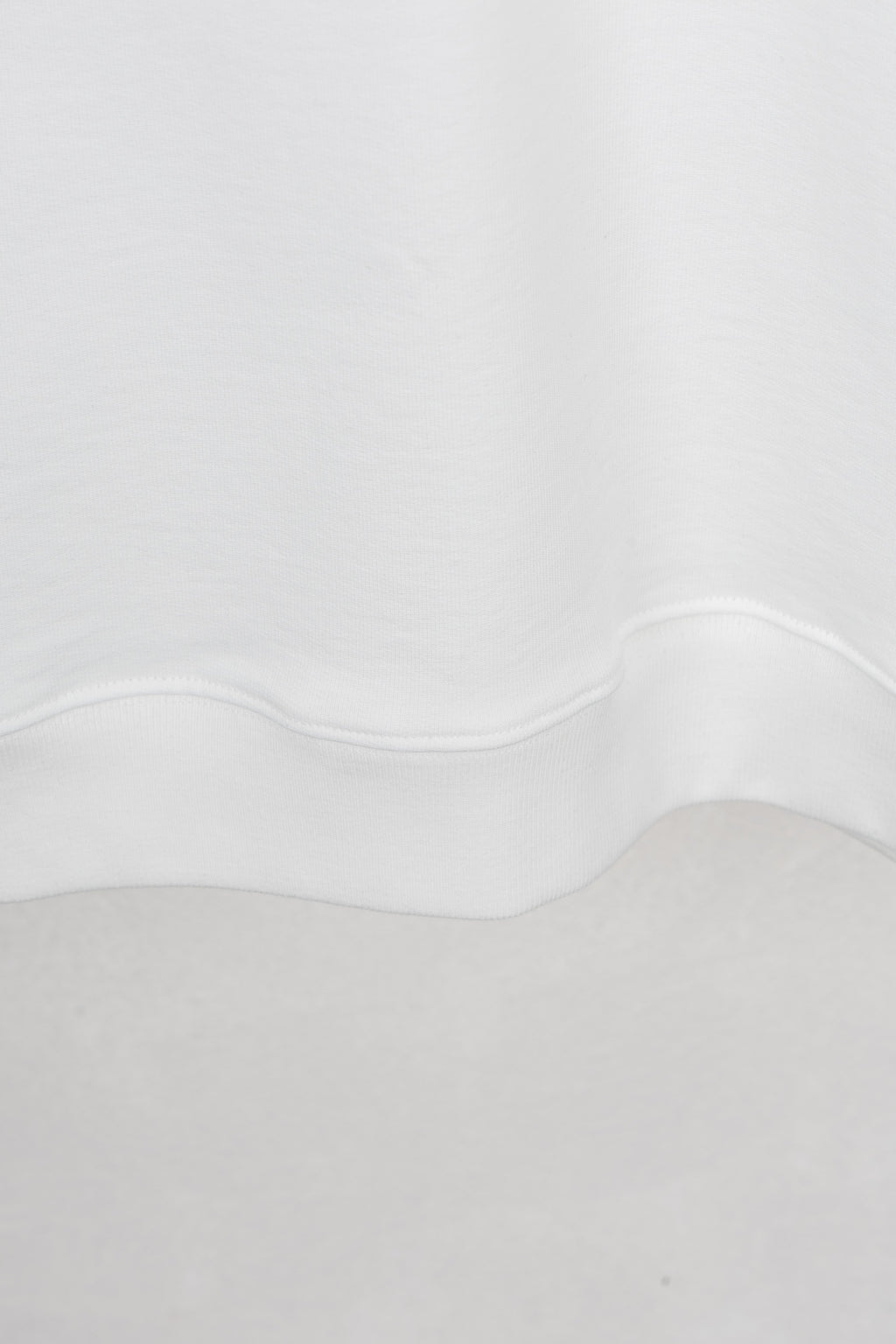 White sweatshirt neckline and hem with curved seam detail