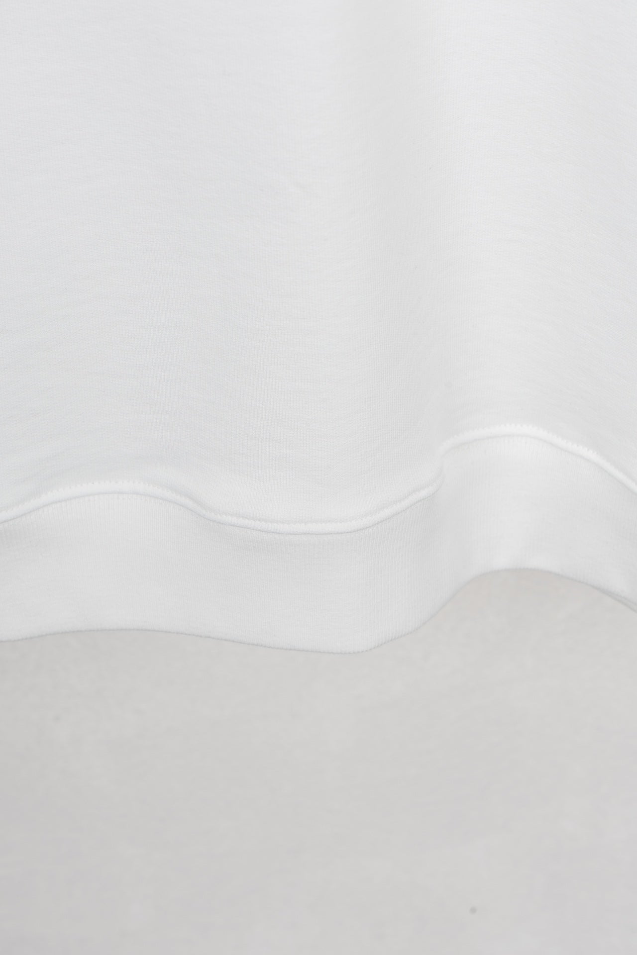 White sweatshirt neckline and hem with curved seam detail