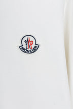 White sweatshirt with embroidered logo patch on the chest