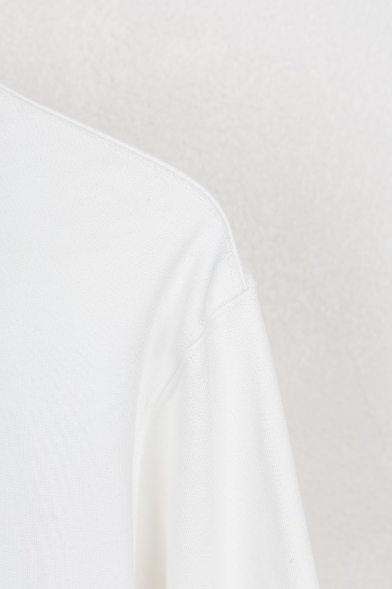 White long-sleeve sweatshirt shoulder seam and smooth knit