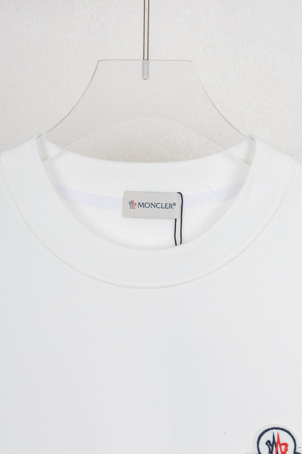 White crew-neck sweatshirt neckline with inner brand label