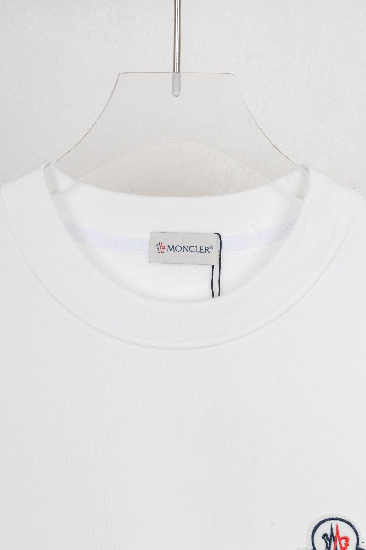 White crew-neck sweatshirt neckline with inner brand label