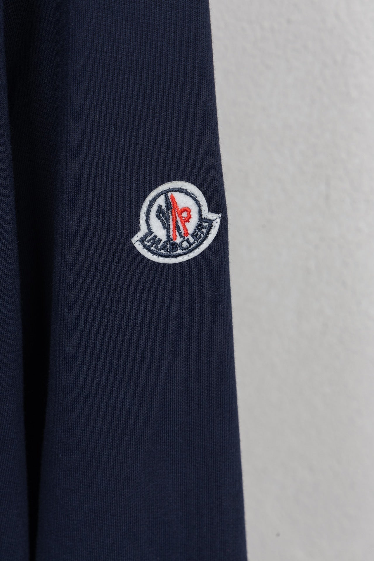 Moncler dark navy sleeve with circular crest patch