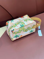 Louis Vuitton mini crossbody bag with floral toucan print, zip top, yellow strap and tag.