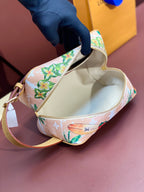 Louis Vuitton mini crossbody bag open, cream interior, zip top, floral toucan print.