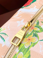 Louis Vuitton zipper pull, floral toucan pattern on light canvas with gold hardware.