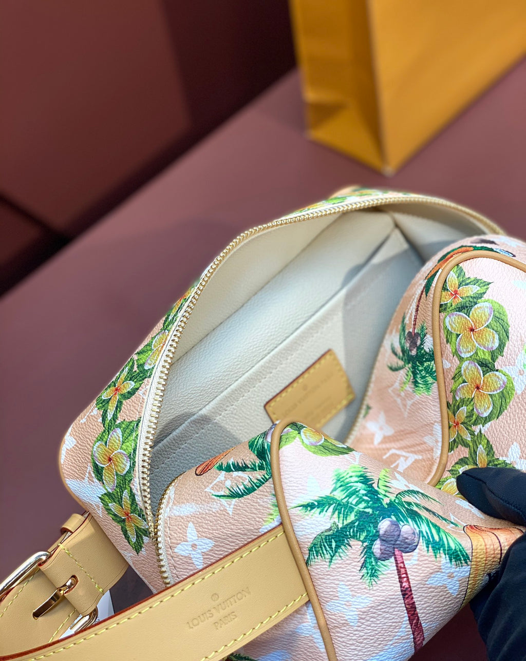 Louis Vuitton mini crossbody bag interior view, cream lining, zipper, floral toucan print.