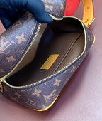 Louis Vuitton bag interior close-up with brown lining, zipper, and small leather patch