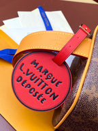 Louis Vuitton bag pink round luggage tag reading Marque VuittiN Depesce