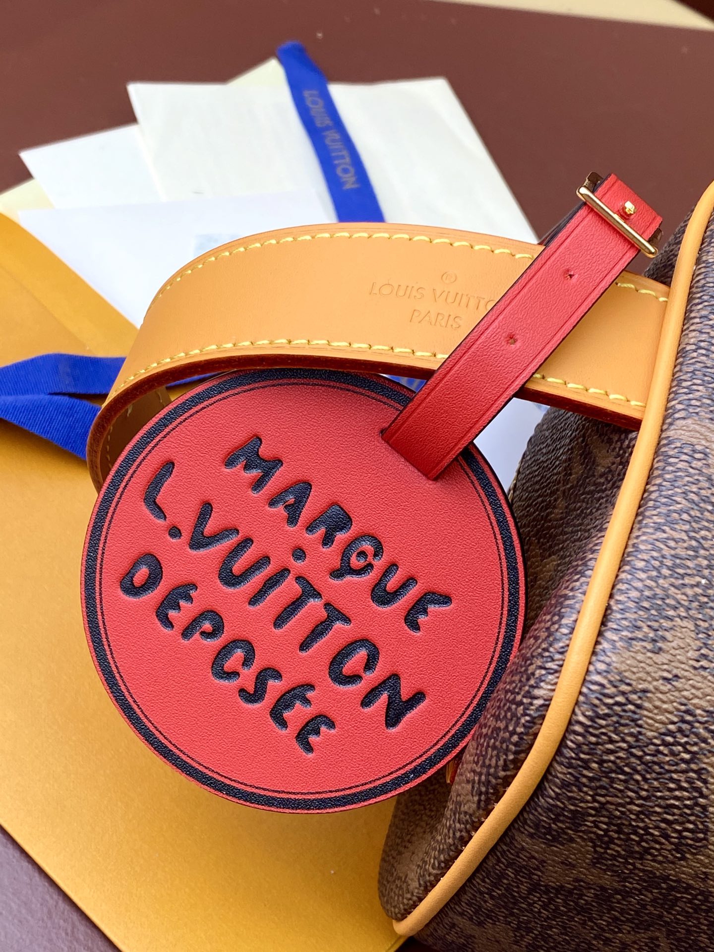 Louis Vuitton bag pink round luggage tag reading Marque VuittiN Depesce