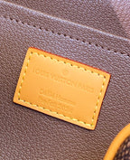 Louis Vuitton bag leather label close-up with tan stitched rectangle text