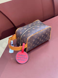 Louis Vuitton bag in brown monogram canvas with tan trim and gold zipper, side view