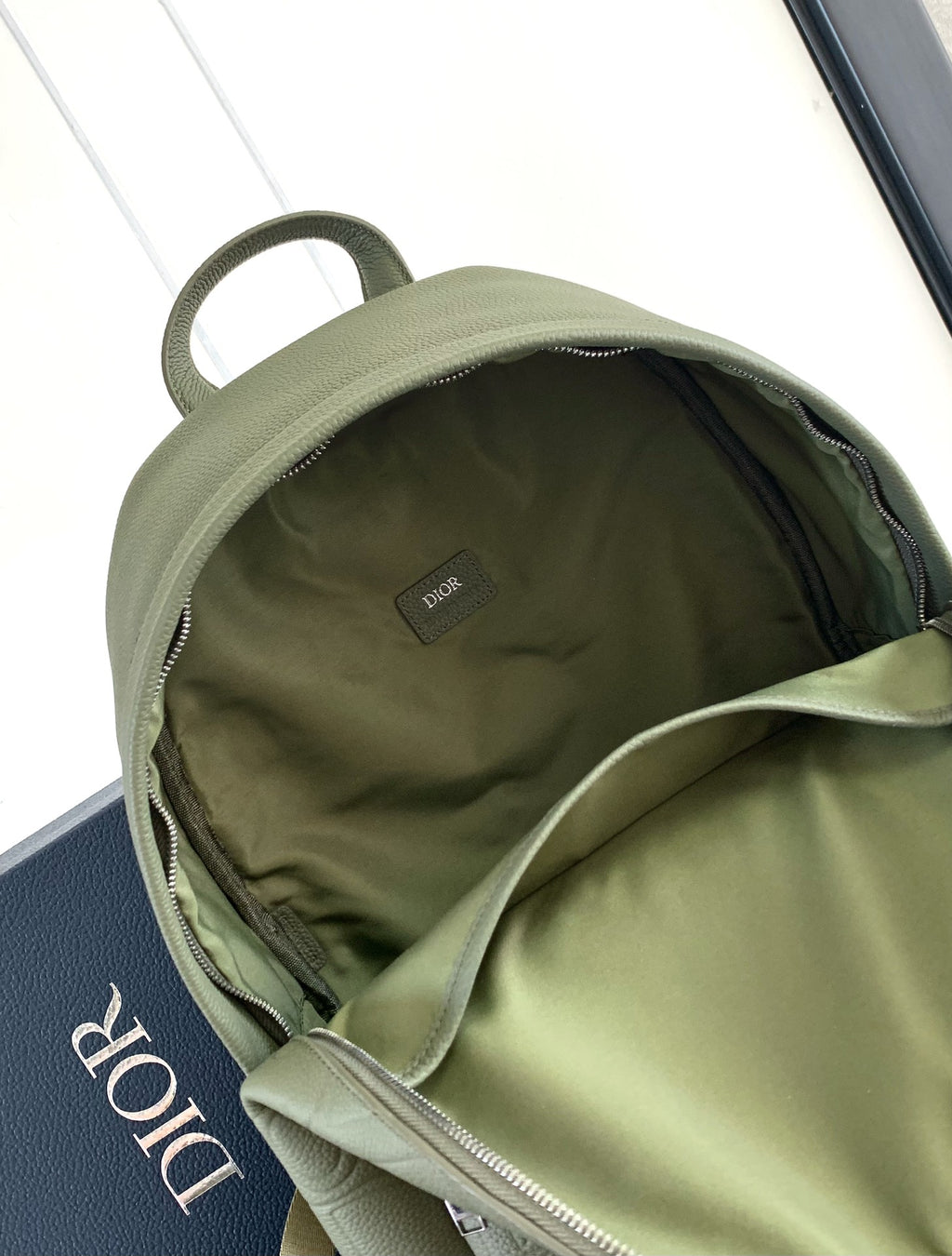 Olive Dior men's backpack interior with open zipper and small logo patch