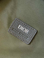 Olive-green Dior fabric brand patch with stitched border and logo