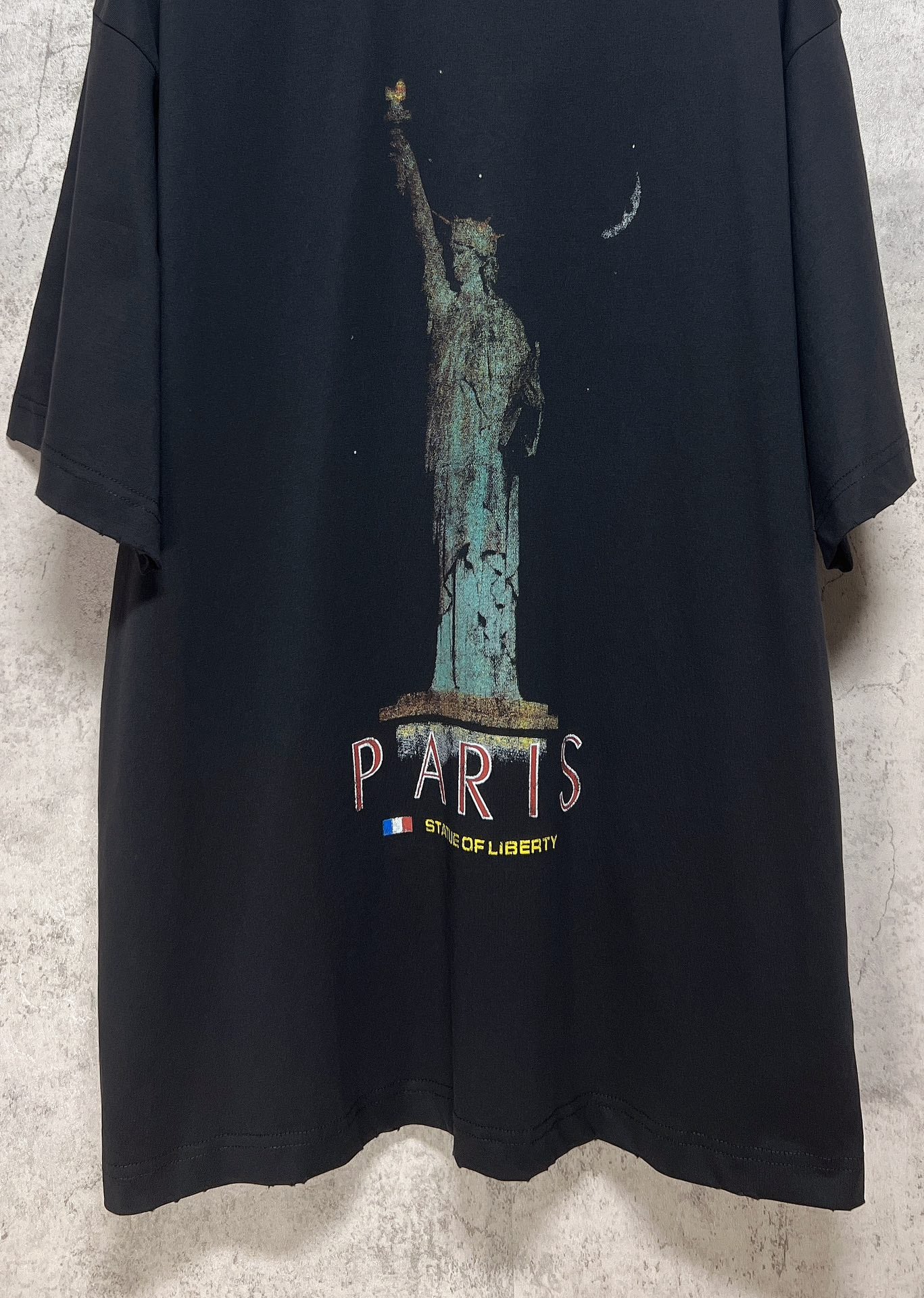 Dark T-shirt front with Statue of Liberty and “PARIS” text print