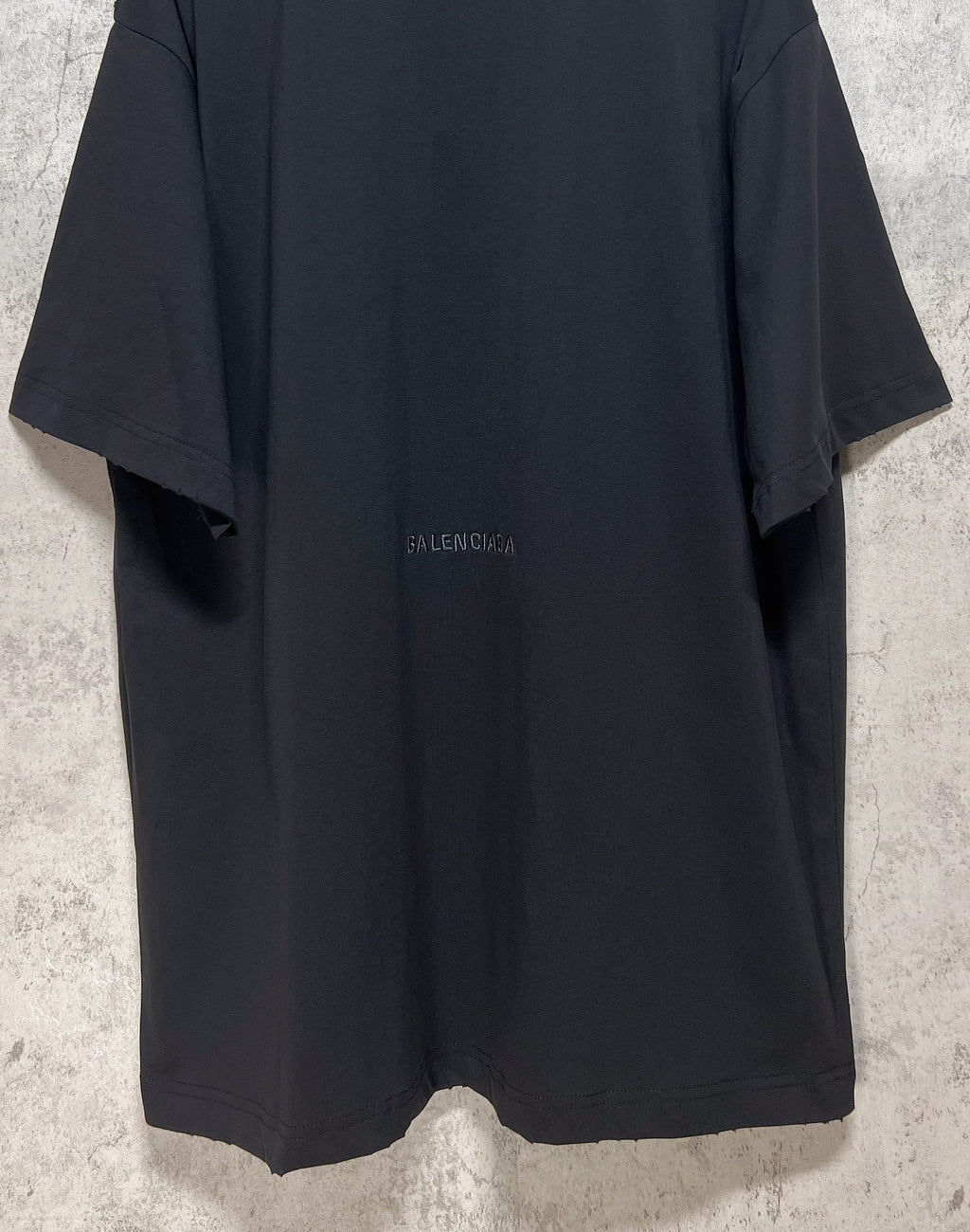 Dark T-shirt back view with small Balenciaga logo centered