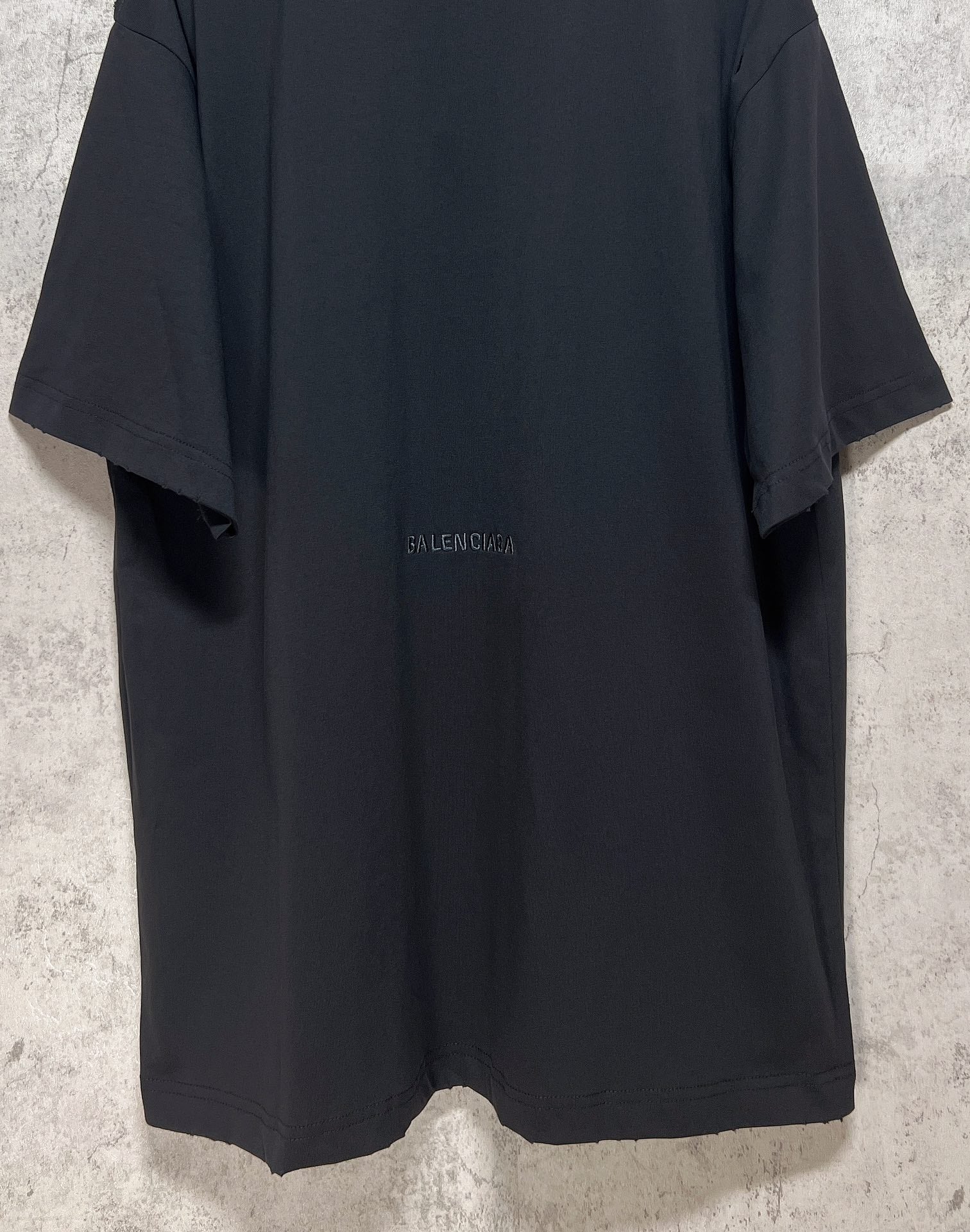 Dark T-shirt back view with small Balenciaga logo centered