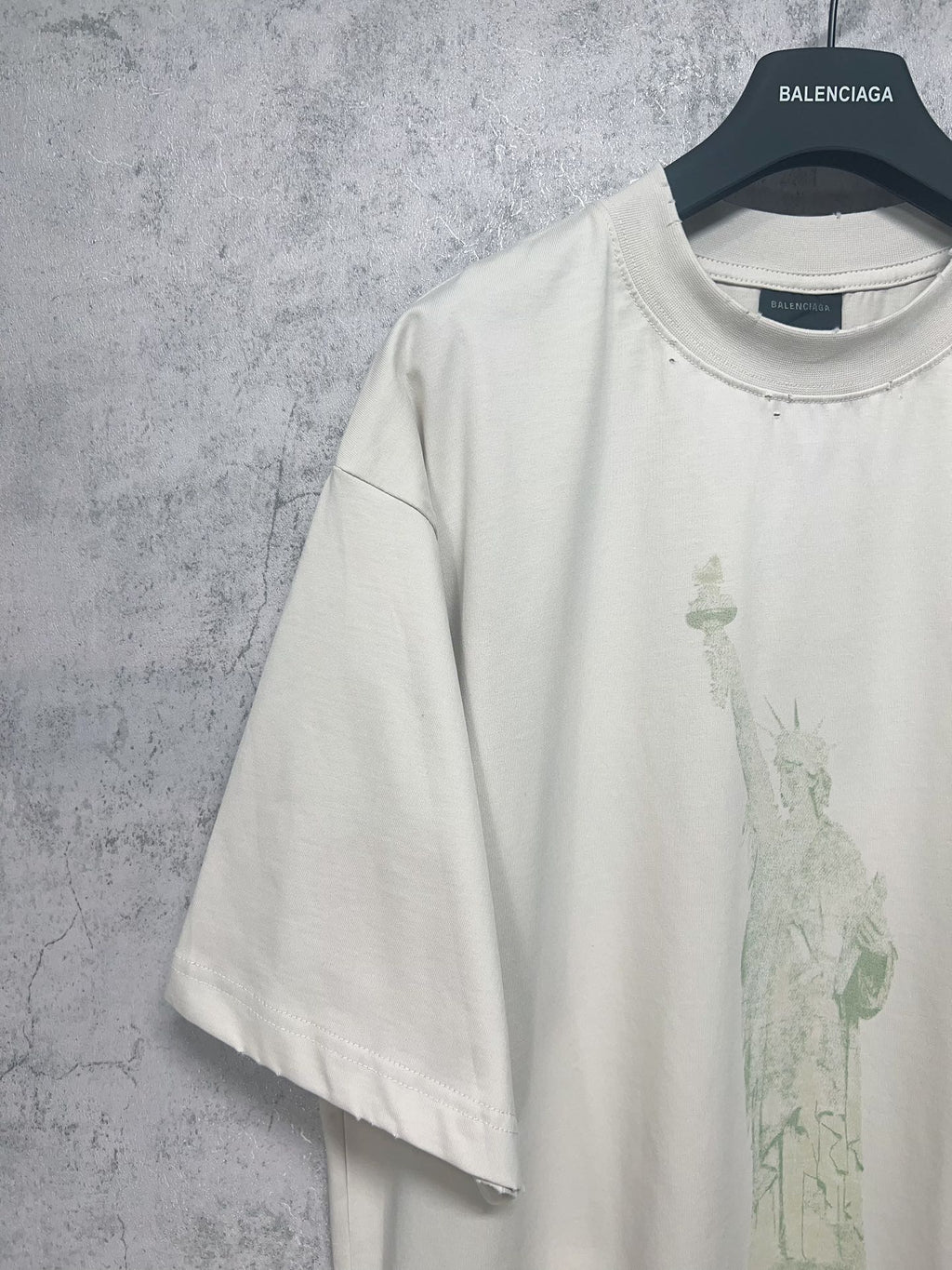 White short-sleeve T-shirt with partial Statue of Liberty print on front panel
