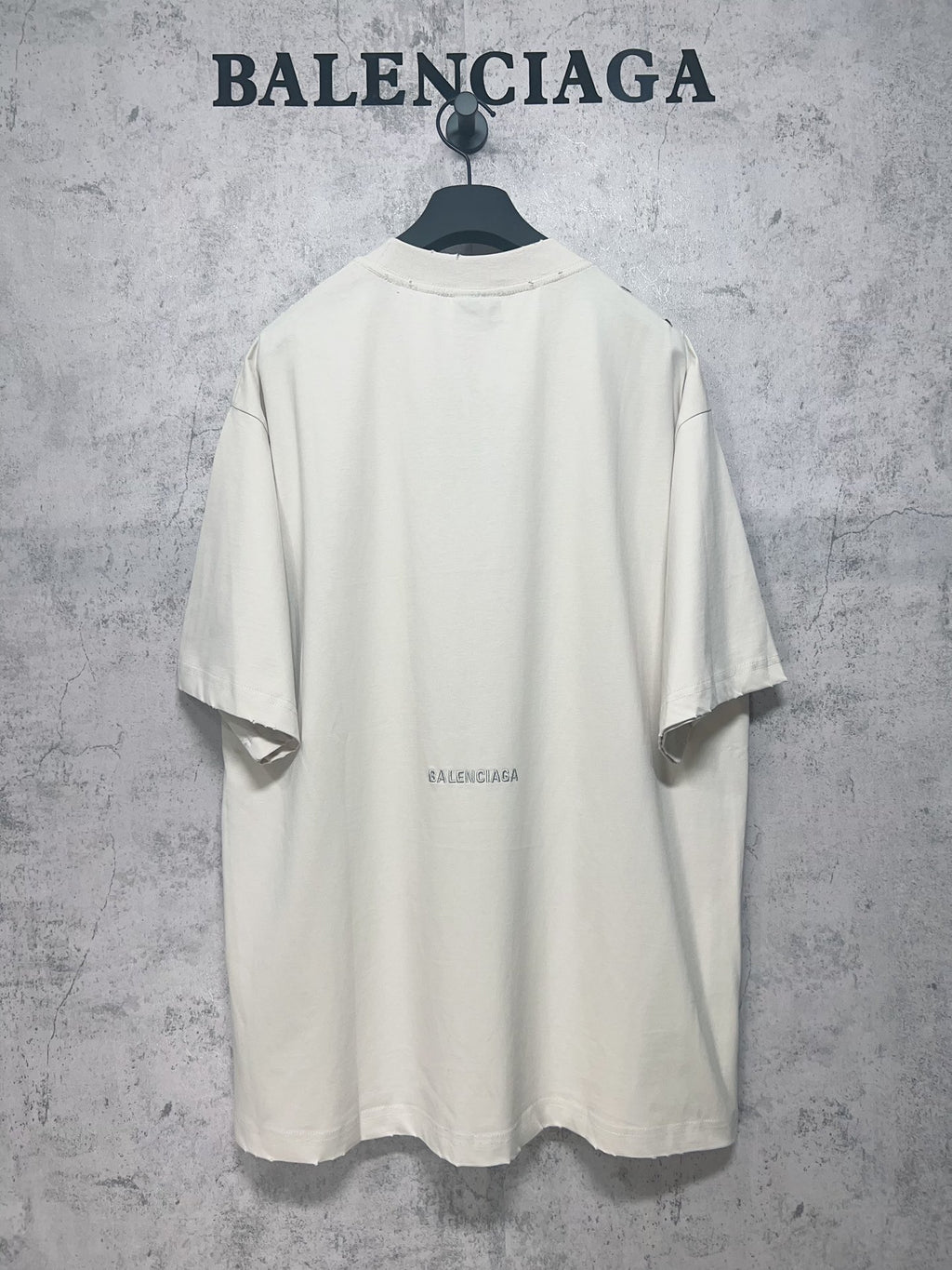Back view of white short-sleeve T-shirt with small centered Balenciaga logo print