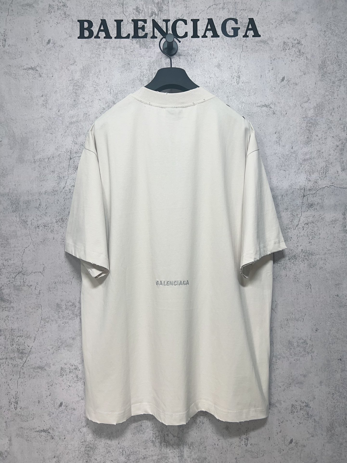 Back view of white short-sleeve T-shirt with small centered Balenciaga logo print