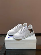 Burberry white low-top sneakers with blue logo, plaid heel panel, and rubber sole