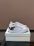 Burberry low-top sneakers in white with blue logo and lace-up front, plaid panel detail