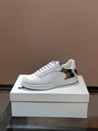 Burberry white lace-up sneakers with blue logo accent on the quarter panel