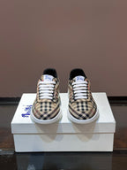 Pair of checkered low-top sneakers, white laces, blue heel detail, rubber sole