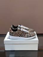 Checkered low-top sneakers with white laces and blue accent, rubber sole